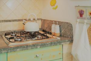 a kitchen with a stove with a tea kettle on it at The Best Nest in Rome