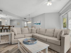 a living room with a couch and a table at Blue Mountain Beach Condominium 102 by Newman-Dailey in Santa Rosa Beach