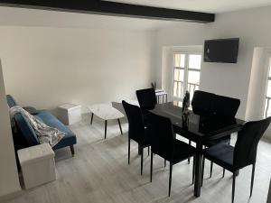 a living room with a dining room table and chairs at Babiloc Moderne à Riez in Riez