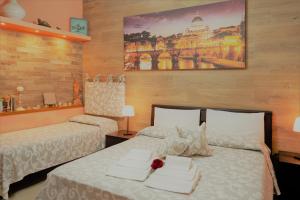 a bedroom with two beds with white sheets at The Best Nest in Rome