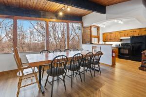 a kitchen and dining room with a large table and chairs at 3 Level Ski Chalet 7BR w Deck, Sauna & Ping-Pong! in Blue Mountains