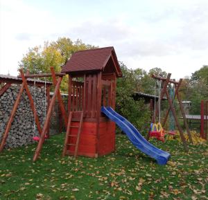 a playground with a slide and a play structure at Ferienwohnung Blick zu den Sternen in Hohenbrück +11 photos