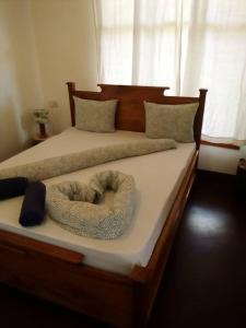 a bed with a wooden frame with a large oar on it at Camp Bastian Mikumi in Mikumi