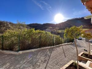 a fence in a yard with the sun in the sky at PRIVATE VILLA - TENNISCOURT in the moutains 19 GUESTS Cairo Montenotte VILLAITALY EU in Cairo Montenotte
