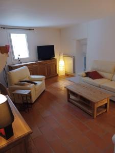 a living room with two couches and a coffee table at Maison de village en pierre in Mollans-sur-Ouvèze