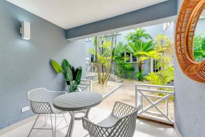 a balcony with a table and chairs and plants at The Palms Resort in Saint James