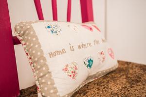a chair with a pillow that says home is where the heart is at Monte de Portugal in Montargil