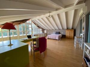 a room with a bed and a table with a laptop at Villa-Agave , by the sea in Porto-Rafti outside Athens in Porto Rafti