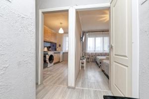 an open door to a kitchen and a room with a bed at Dubnas iela - 6 can stay in Rīga