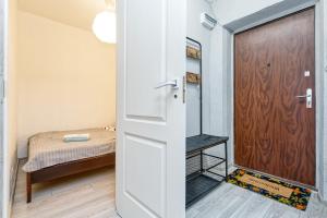 a door leading to a bedroom with a bed at Dubnas iela - 6 can stay in Rīga