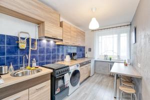 a kitchen with a sink and a washing machine at Dubnas iela - 6 can stay in Rīga