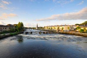 a river with boats in it in a city at Dillon house, Ballina in Ballina