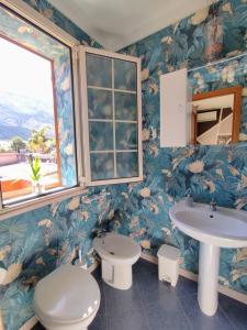 a bathroom with a toilet and a sink at Casa vacanze Isolotto in Isola delle Femmine +42 photos