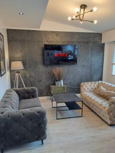 a living room with two couches and a tv at Harrington Suite in Liverpool