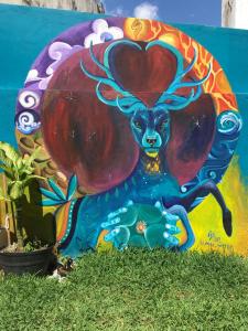 a painting of a deer with a heart on a wall at Venado 28 in Cancún