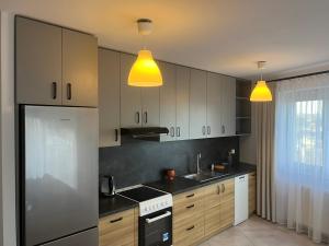 克拉科夫的住宿－Apartament Zlota Jesień 2C，厨房配有白色橱柜和黄色灯