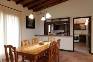 uma cozinha e sala de jantar com uma mesa de madeira e cadeiras em Casa Agostino - Luxury wine and hotel in Bodega Agostino em Mendoza