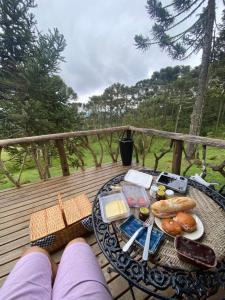 a tray of food on a table on a deck at Refúgio Arati in Rio Rufino