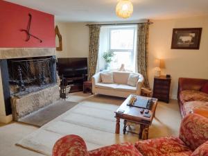 a living room with a couch and a fireplace at Black Dog House in Bishop Auckland