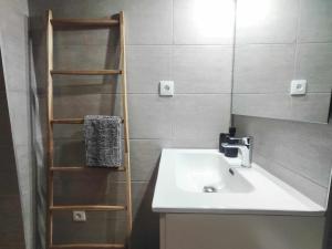 a bathroom with a sink and a book shelf at Mazi Apartments Loft in Mataró