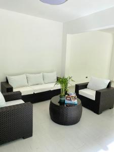 a living room with two couches and a coffee table at The White Rock Hotel B&B in Los Conucos