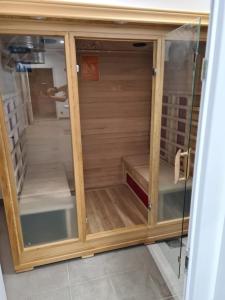 a wooden cabinet with glass doors in a room at Domaine de Montcausson in Revel