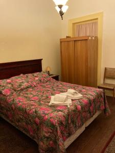a bedroom with a bed with a robe on it at Hostal Residencia en el Cerro in Valparaíso
