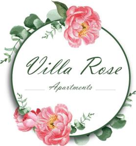 una corona de flores rosas sobre un fondo blanco en Villa Rose Apartments, en Sant'Egidio del Monte Albino