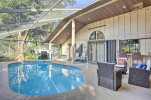 a swimming pool in a house with a patio at Stuart Vacation Rental Walk to Private Boat Dock! in Stuart