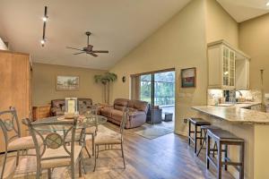 a kitchen and living room with a glass table and chairs at Stuart Vacation Rental Walk to Private Boat Dock! in Stuart