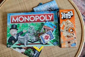 a board game with monopoly and other toys on a plate at Private Boho Bungalow 10 Minutes to Downtown RVA! in Richmond