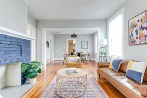 a living room with a couch and a table at Private Boho Bungalow 10 Minutes to Downtown RVA! in Richmond