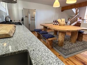 a kitchen with a wooden table and a counter top at Arrayanes Royal in Sierra Nevada