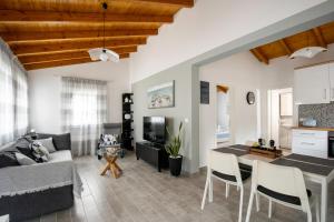 a living room with a couch and a table at CASA DI'ELEN in Faliraki