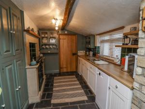a kitchen with a sink and a counter top at Cholmley Cottage in Whitby
