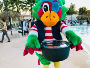 a mascot holding a bowl of water at a pool at Mobil home 6/8 personnes camping 4*Frejus in Fréjus