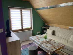a living room with a couch and a table at Sigis Fewo - Monteurwohnung in Erbendorf