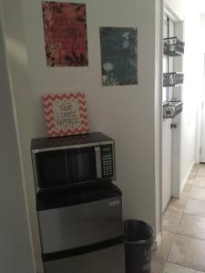 a microwave oven sitting on top of a refrigerator at Lake Shores Suites in Shady Shores