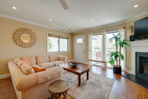 a living room with a couch and a fireplace at Condo with 2 Decks - Steps to Wrightsville Beach! in Wrightsville Beach