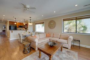 uma sala de estar com um sofá e uma mesa em Condo with 2 Decks - Steps to Wrightsville Beach! em Wrightsville Beach