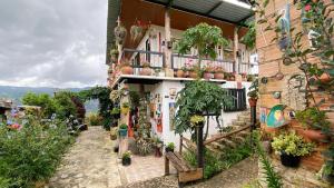 a building with potted plants on the side of it at Finca Renacer in Tibaná