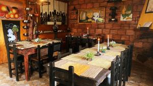 a dining room with a table and chairs with candles on it at Finca Renacer in Tibaná