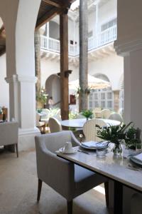 a dining room with a table and chairs in a building at Casa Pestagua Relais Châteaux in Cartagena de Indias
