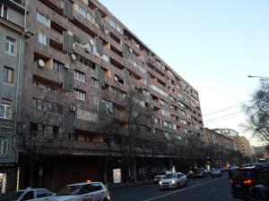 a large building on a city street with cars at Luxury Apartments in Center in Yerevan
