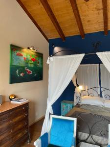 a bedroom with a bed with a blue wall at Verdmont in Acqui Terme
