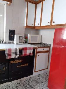 a kitchen with a stove top oven next to a counter at VUT El Refugio in Villablino +23 photos