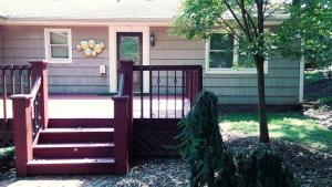 a house with a red gate and a tree at Private Apartment Furnished Great for Business Traveler in Whitehouse