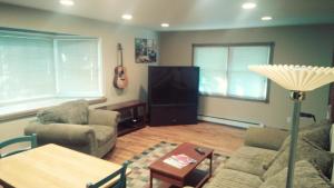 a living room with a couch and a tv at Private Apartment Furnished Great for Business Traveler in Whitehouse