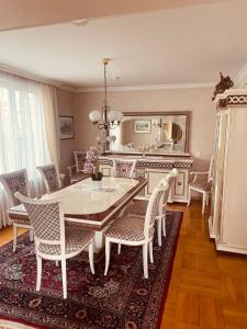 a dining room with a table and chairs and a mirror at Haus Bohle in Dornbirn