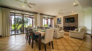 a living room with a dining room table and chairs at Bougainvillea 3103 Luxury Apartment - Reserva Conchal in Brasilito